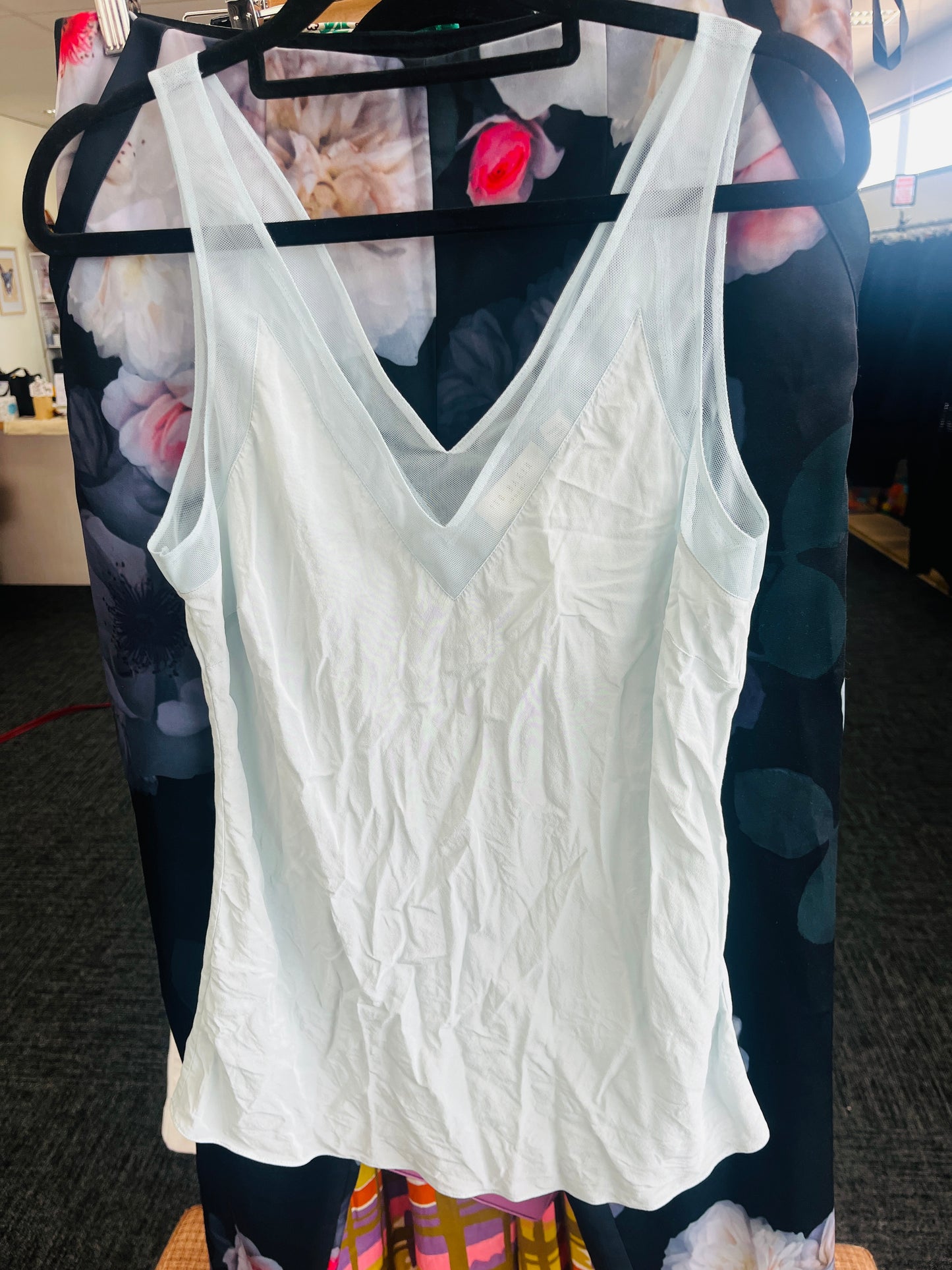 White lace tank top on a hanger