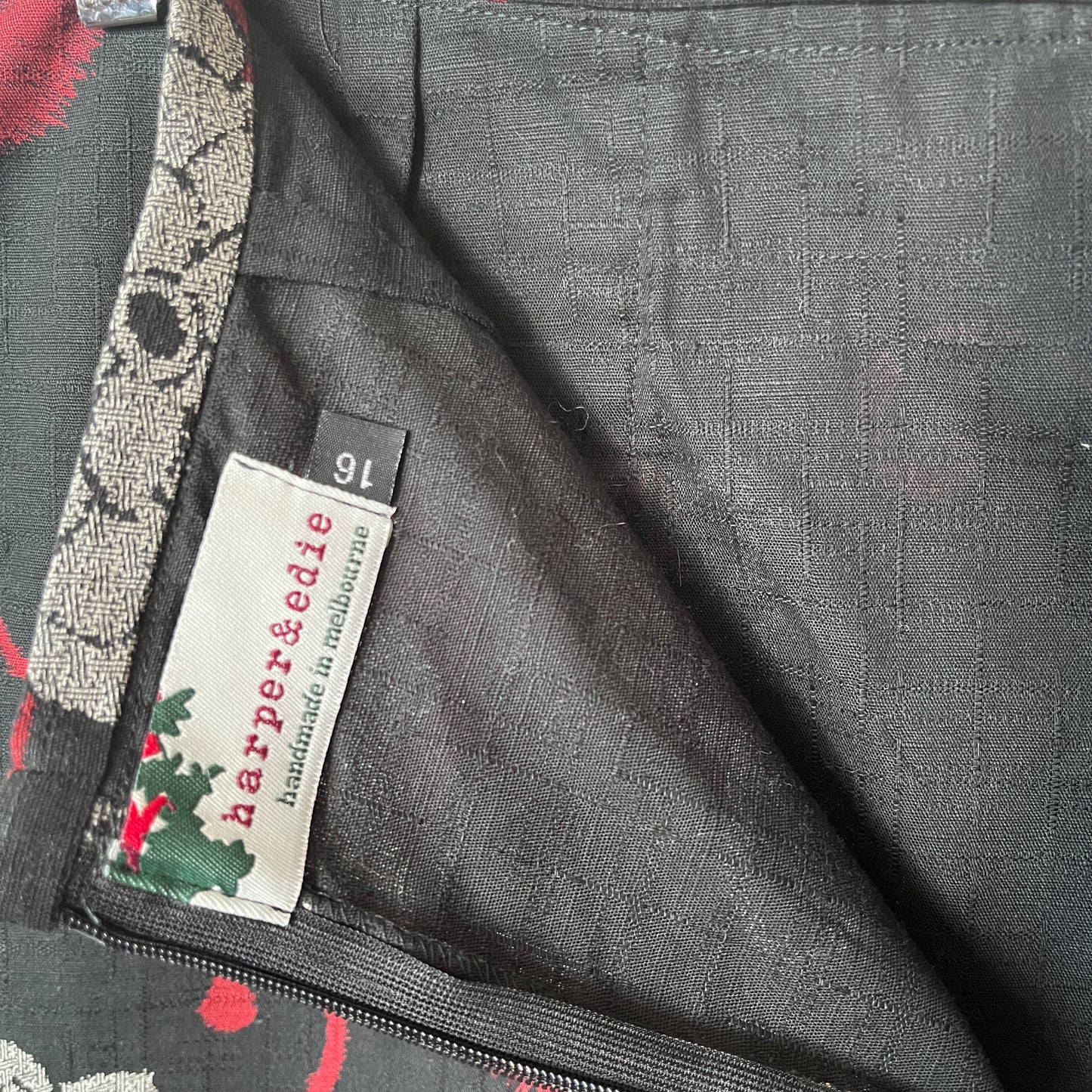Close-up of a label on a garment with floral patterns and 'harper&edie' branding.