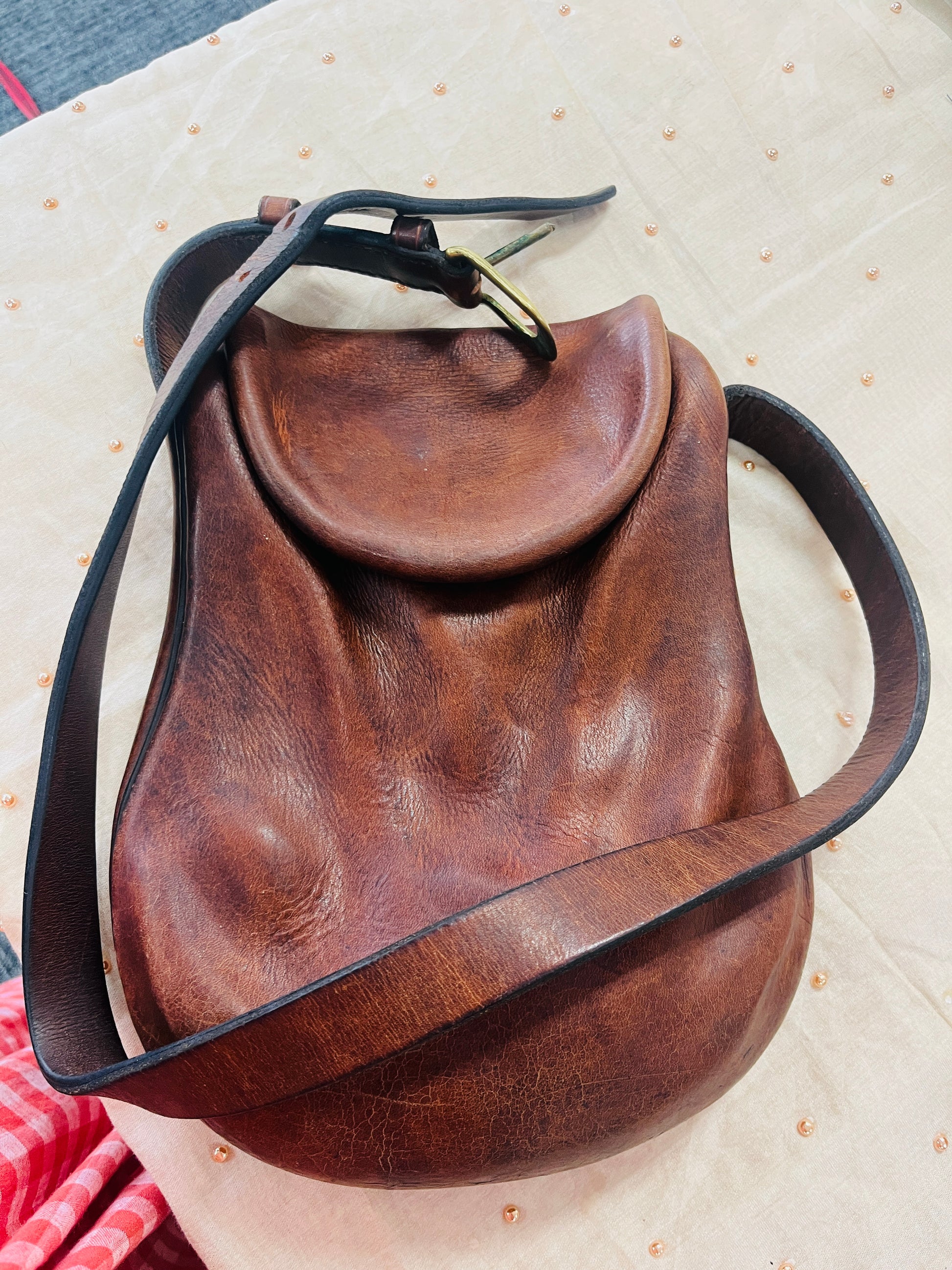 Brown leather bag with black strap
