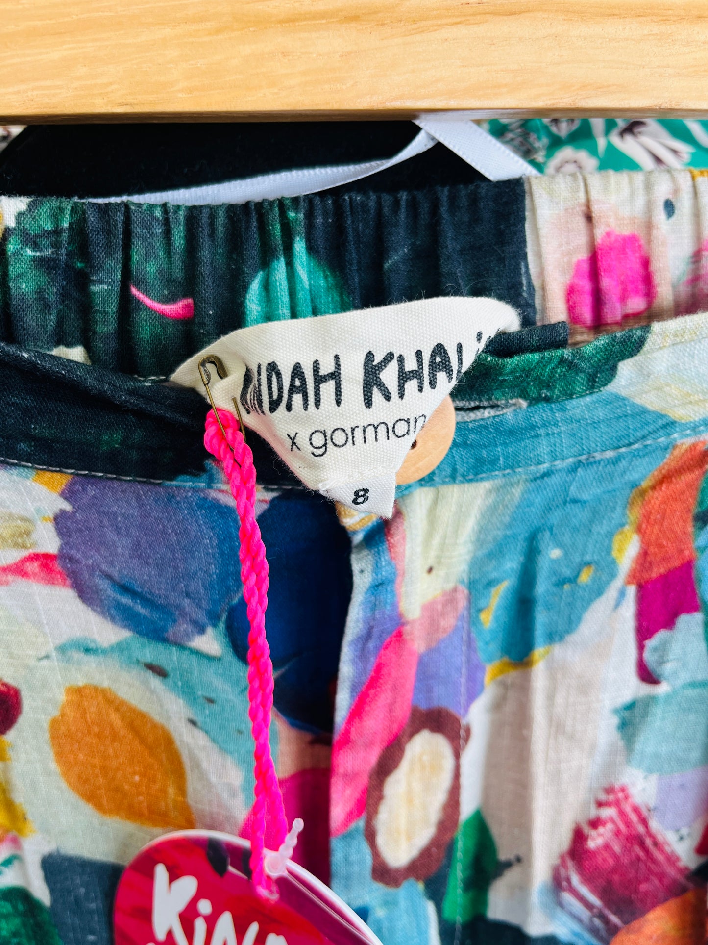 Colorful garment with a brand tag and pink string