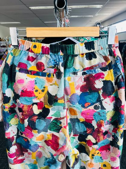 Colorful patterned pants on a hanger