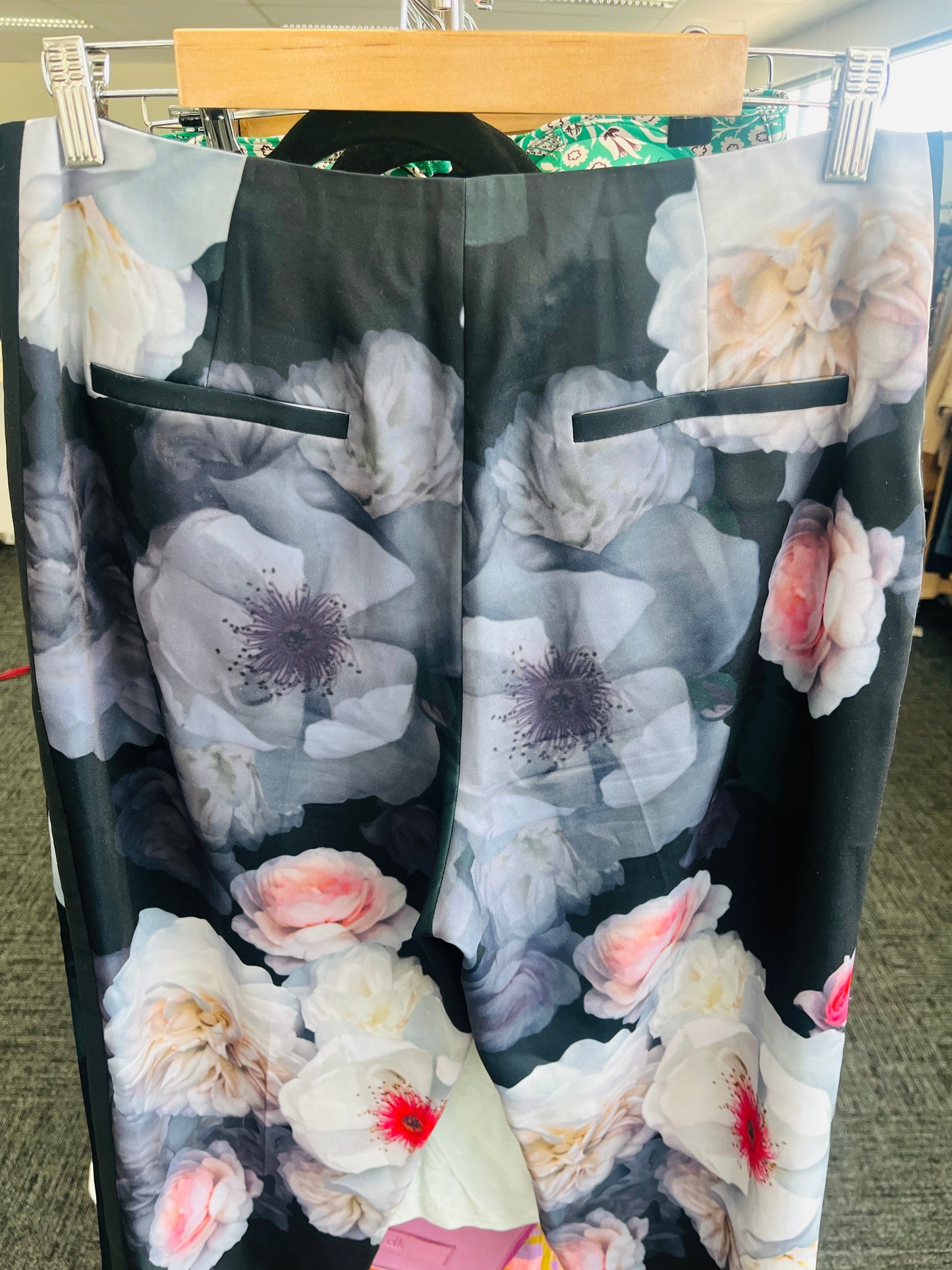 Floral-patterned pants on a hanger