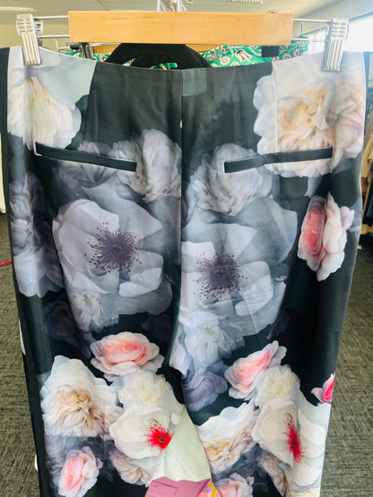 Floral-patterned pants on a hanger