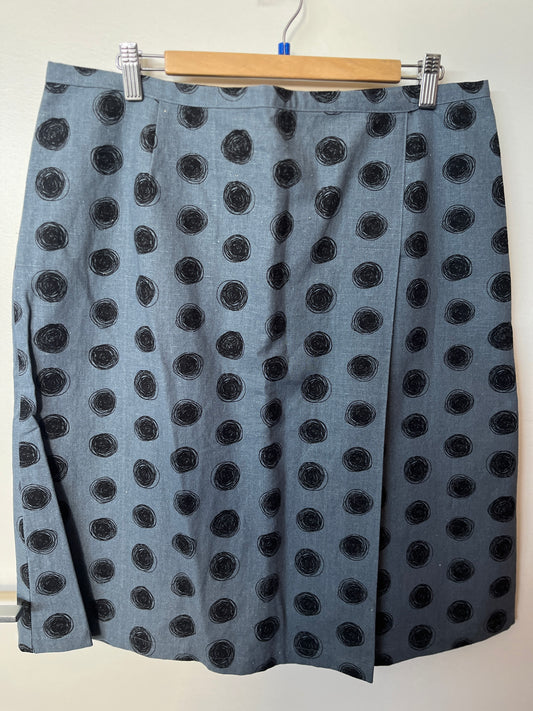 Gray skirt with black polka dots on a hanger