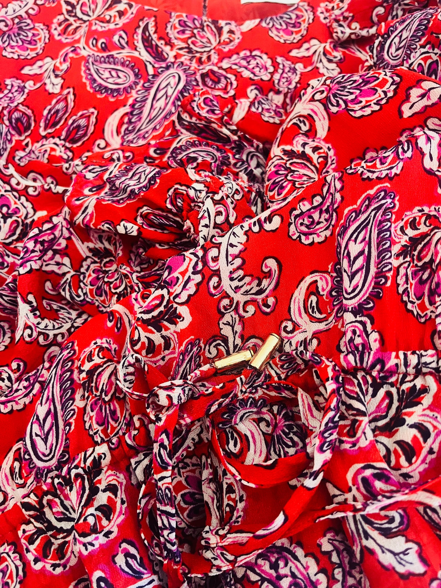 Red fabric with pink paisley pattern