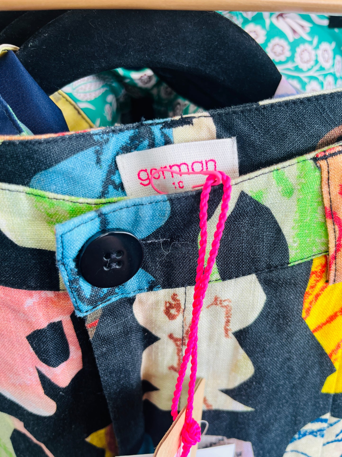 Floral-patterned fabric with a button and 'German' label