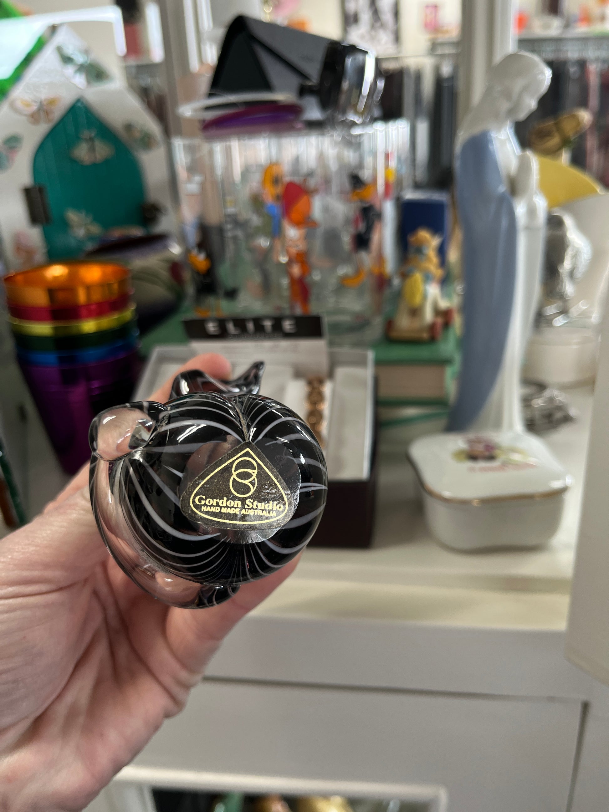 Hand holding a black and gold object