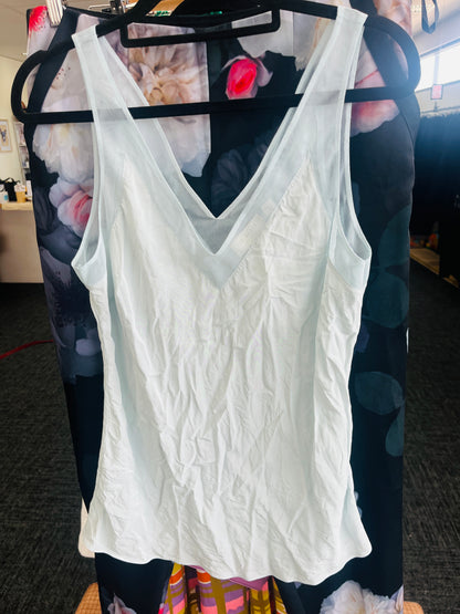White lace tank top on a hanger