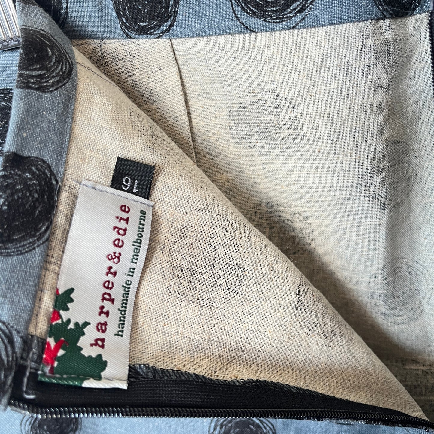 Fabric with a pattern and a visible label on a textured surface