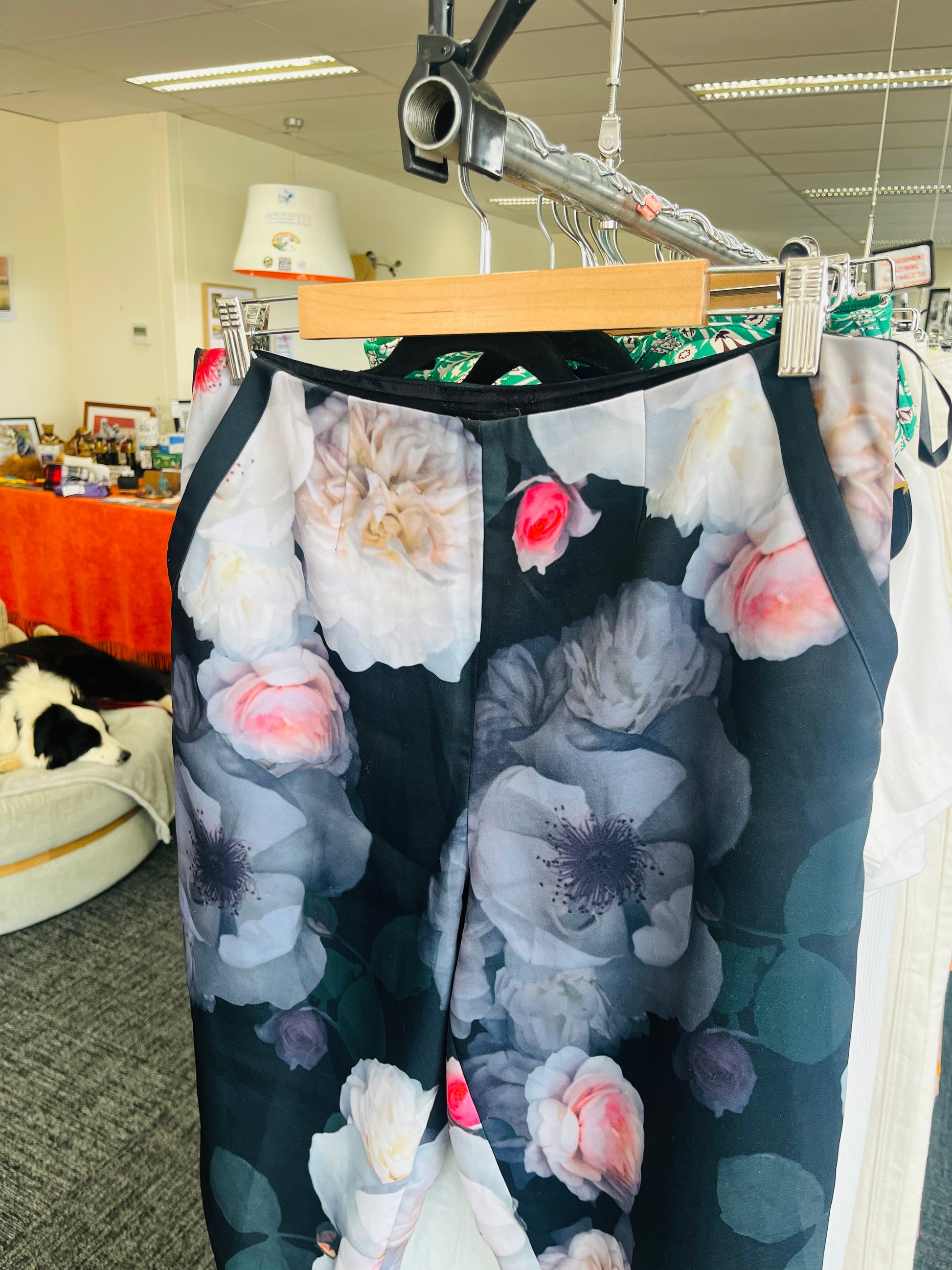 Floral-patterned pants on a hanger