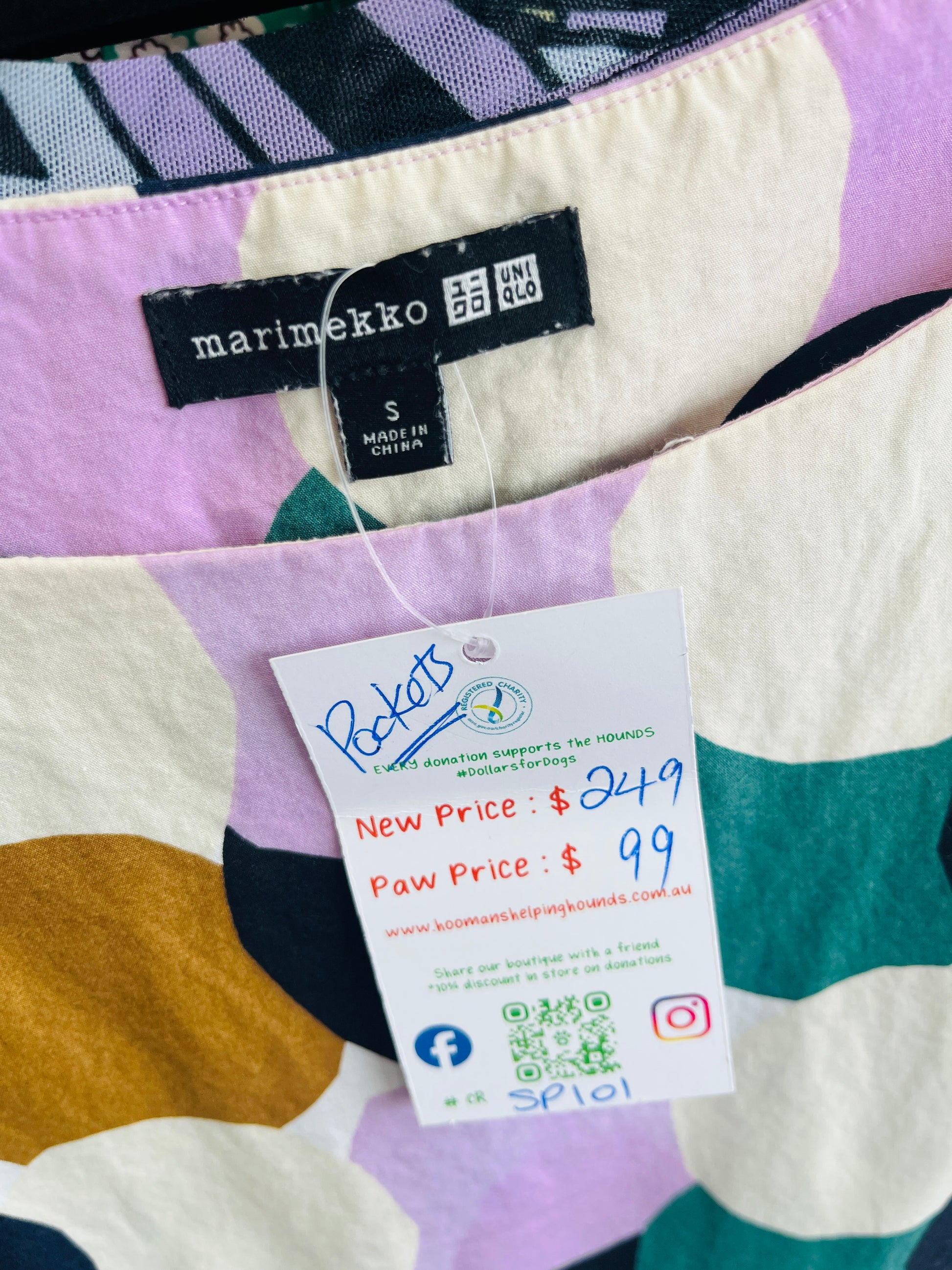 Colorful fabric with a Marimekko label and a price tag on a multicolored background