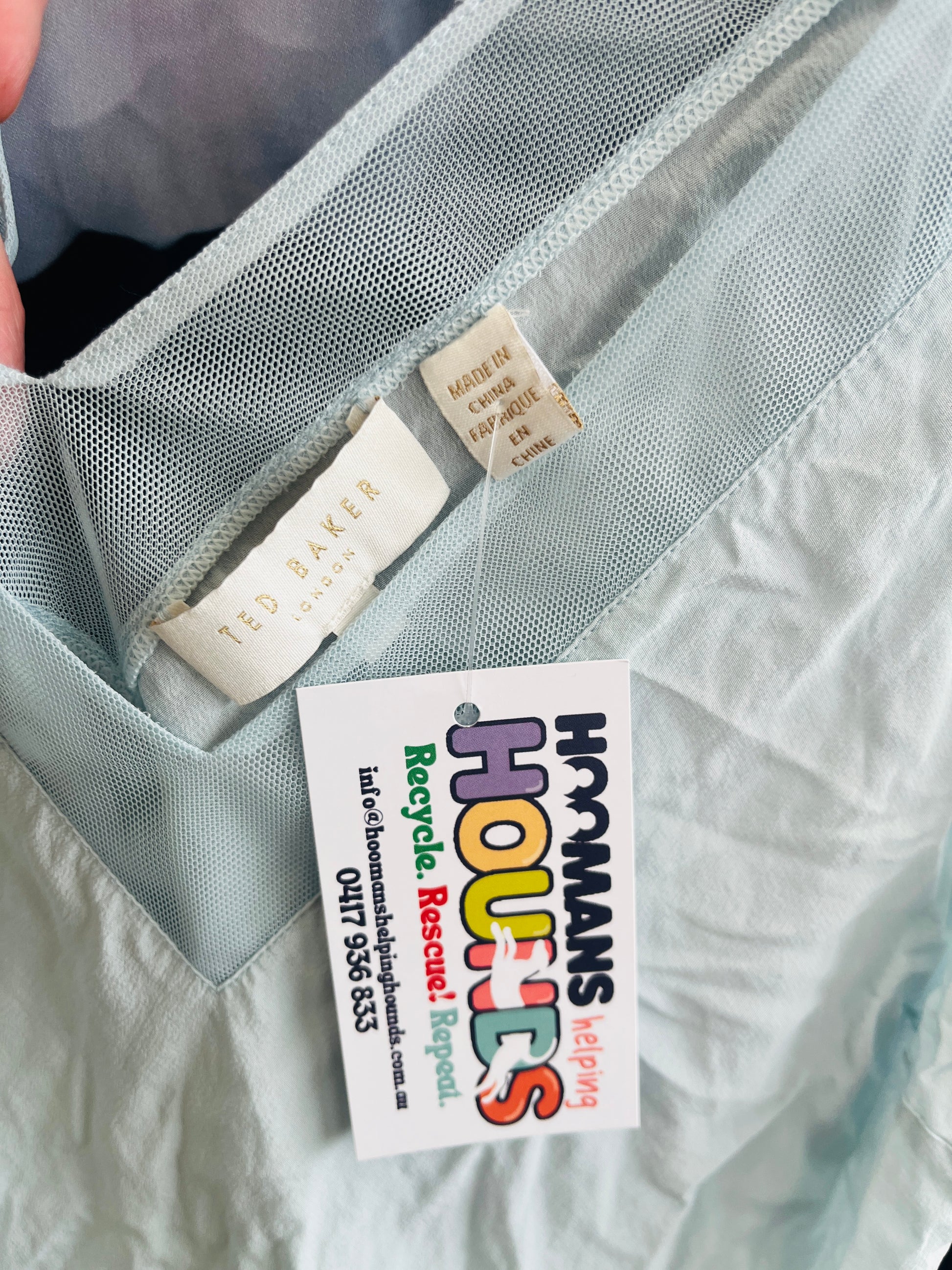 Close-up of a garment with a colorful tag