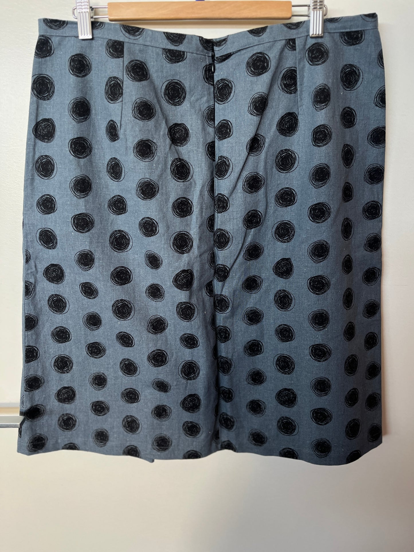 Black polka dot skirt on a hanger