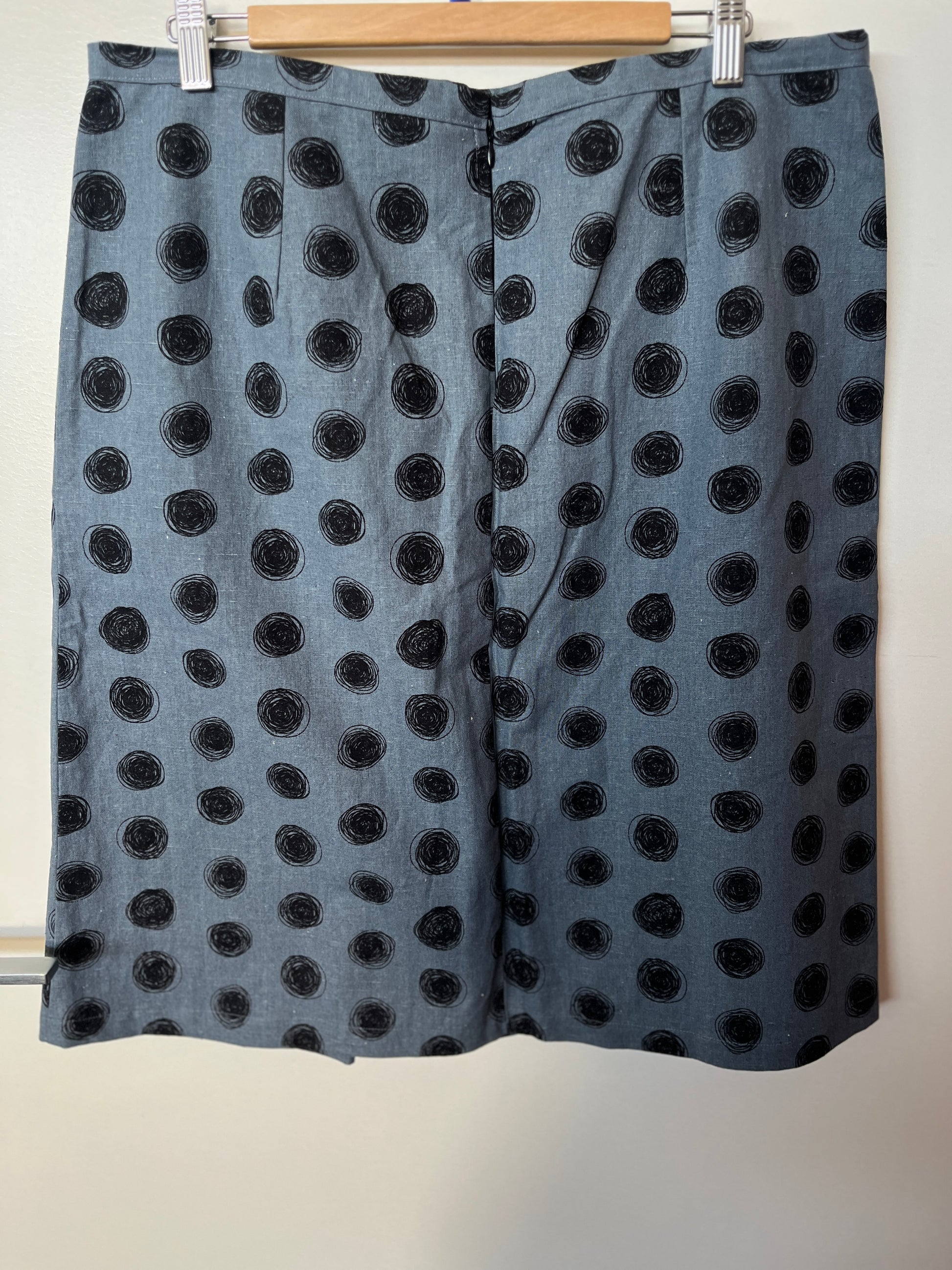 Black polka dot skirt on a hanger