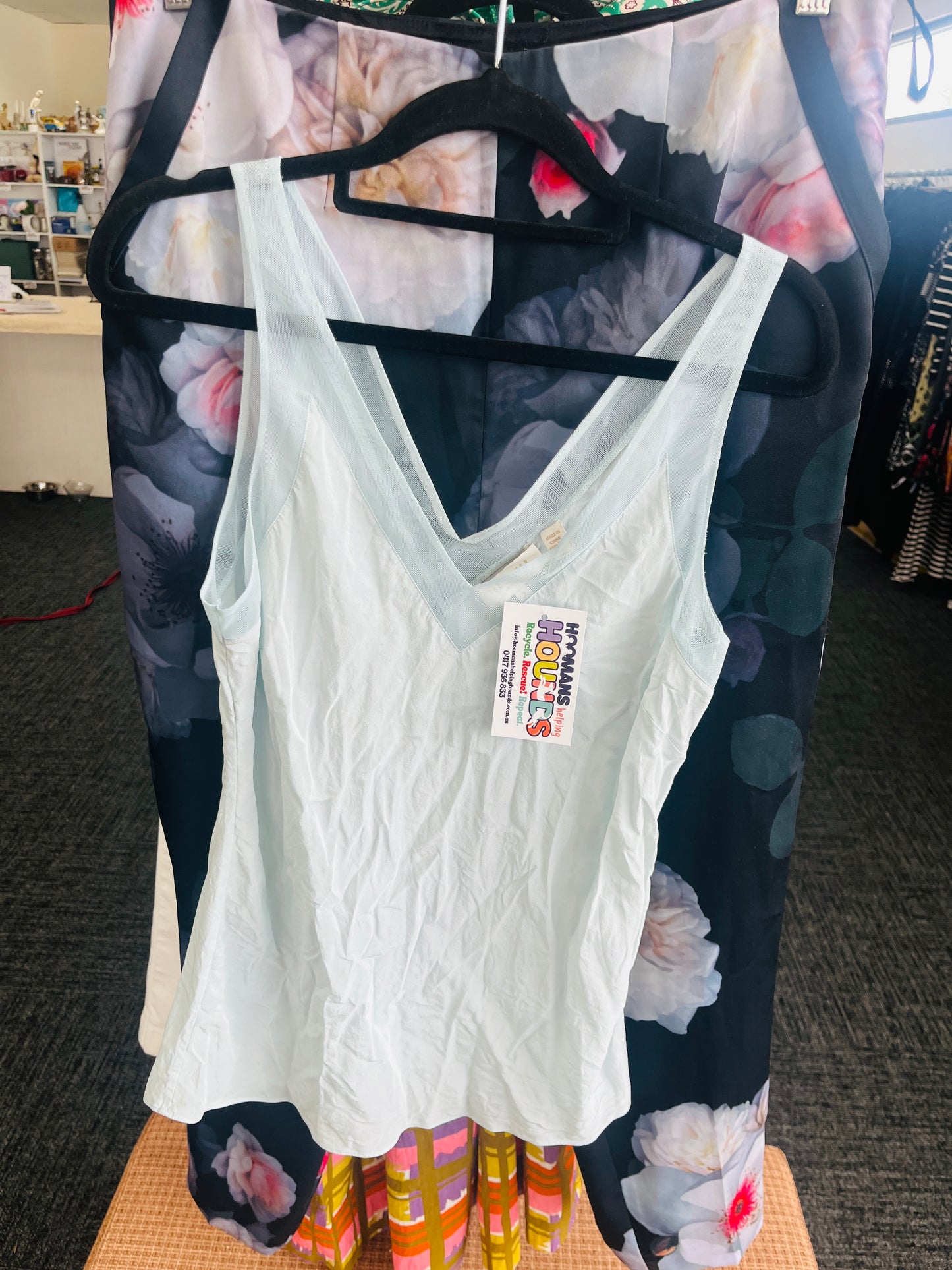 White tank top on a floral-patterned hanger