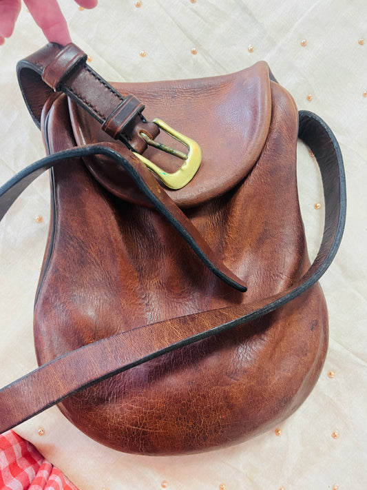 Brown leather bag with a gold buckle