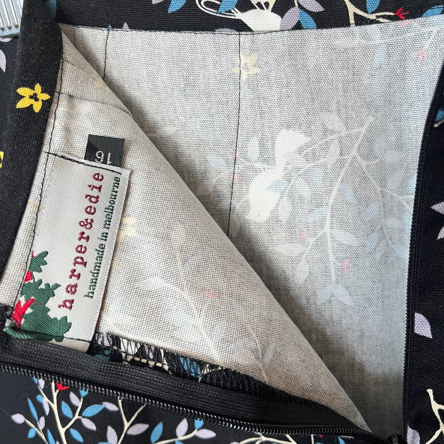 Close-up of a fabric with floral pattern and 'harper&edie' label.