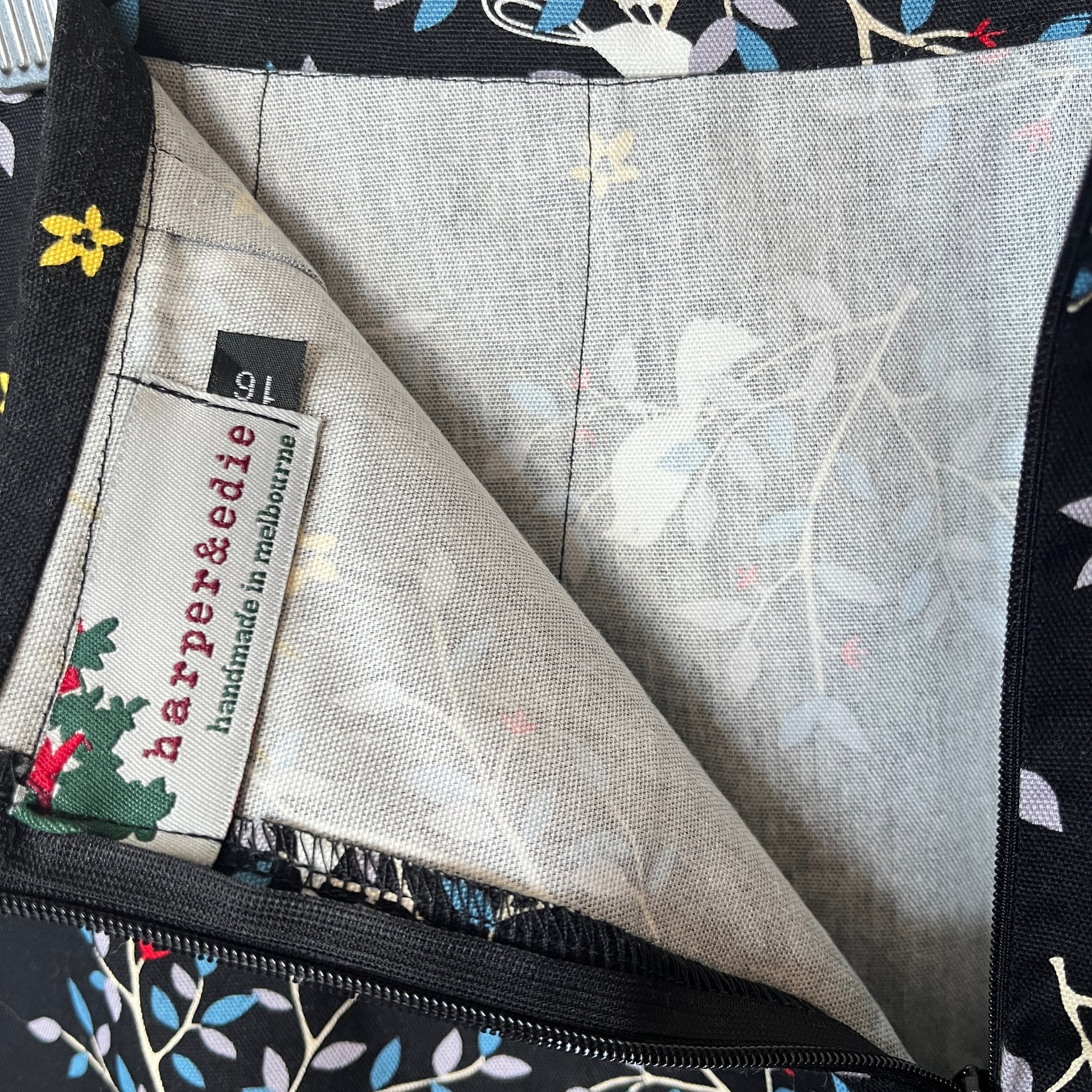 Close-up of a fabric with floral pattern and 'harper&edie' label.
