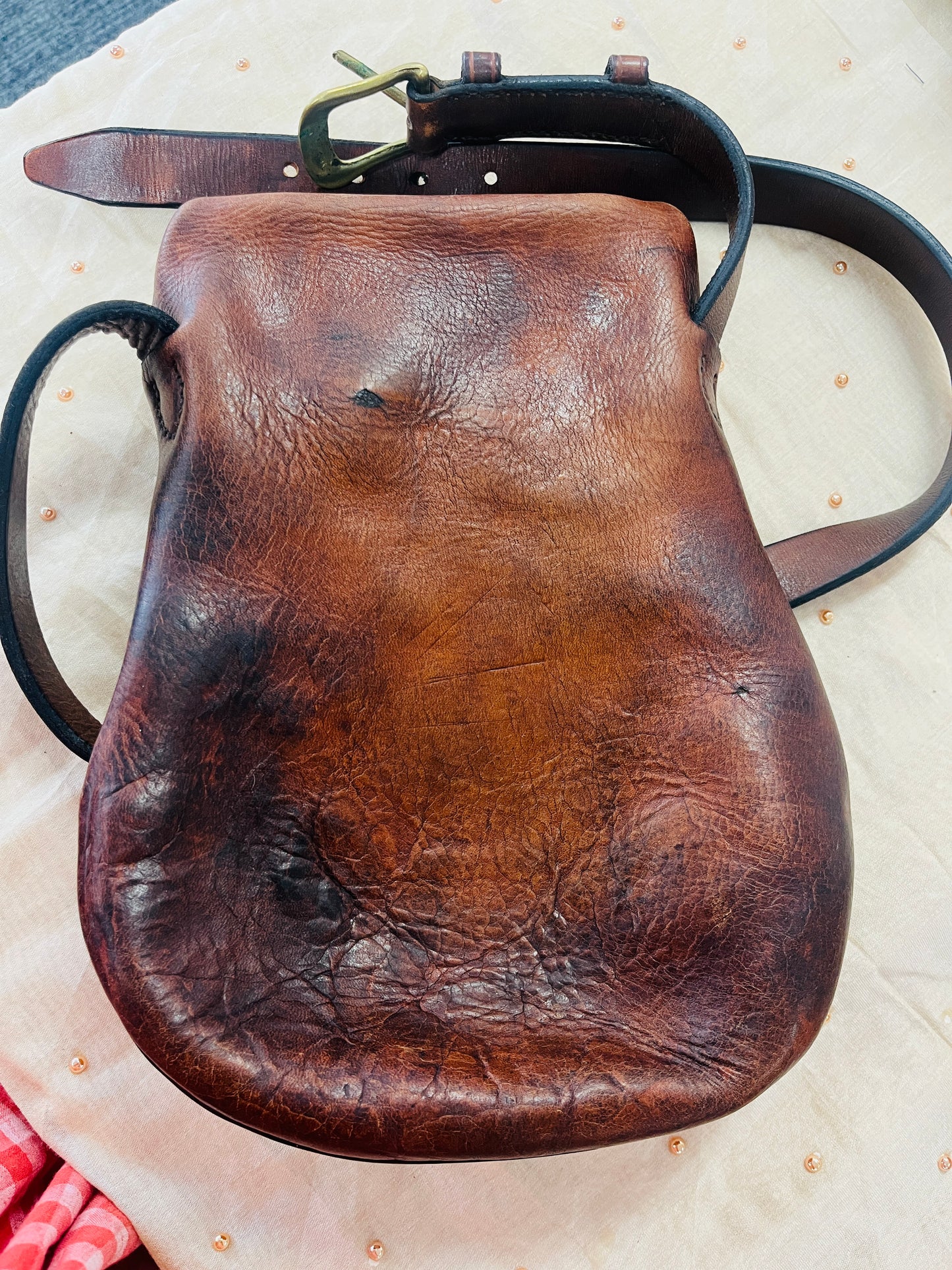 Brown leather pouch with a strap