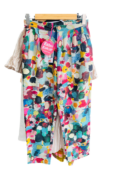 Colorful patterned pants with a tag