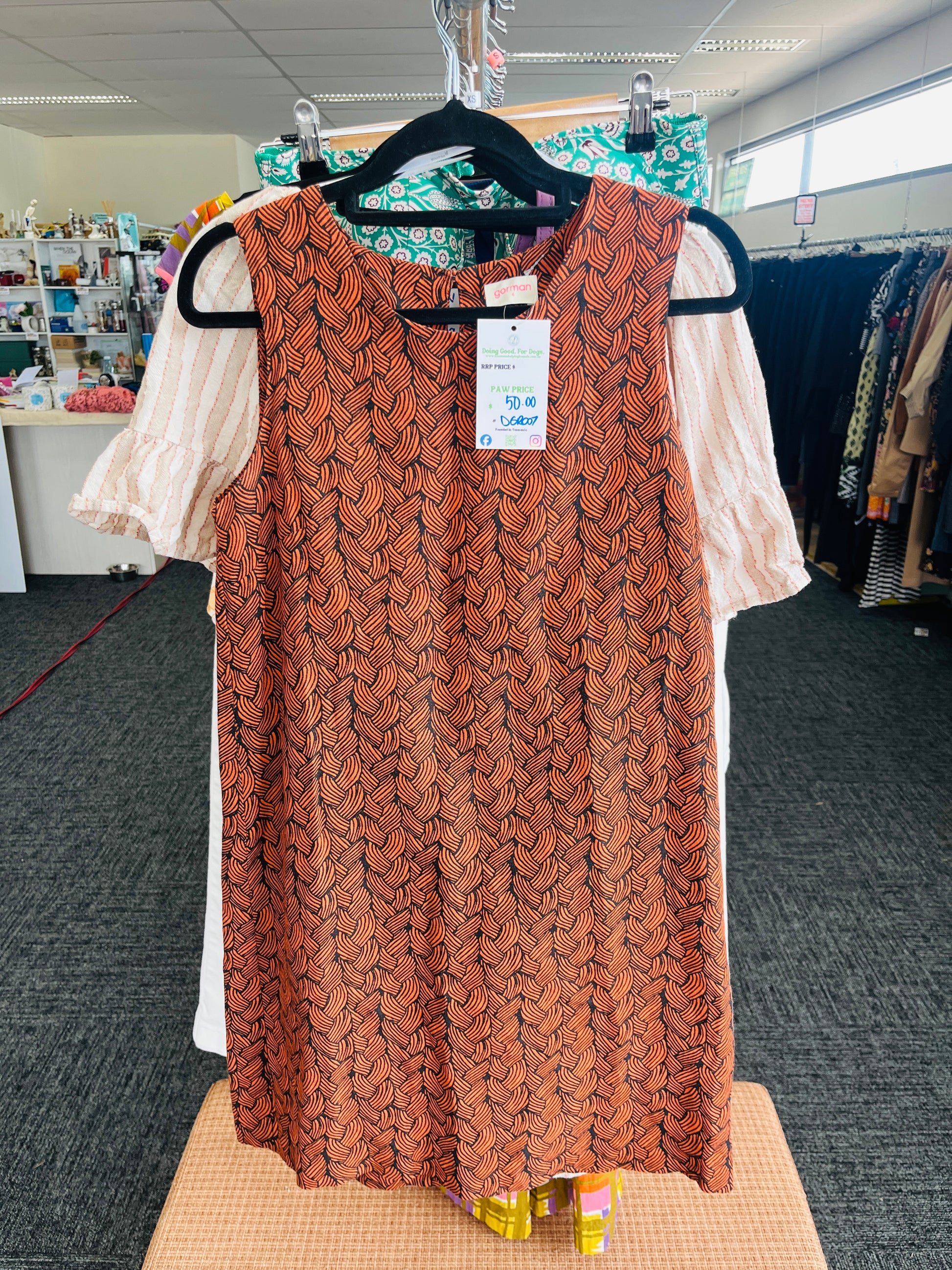 Brown patterned dress on a hanger