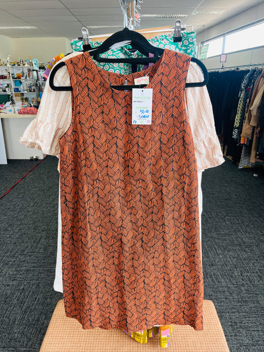 Brown patterned dress on a hanger