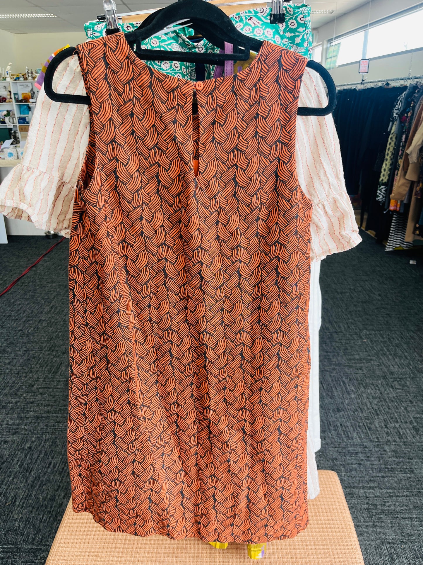 Patterned sleeveless top on a hanger