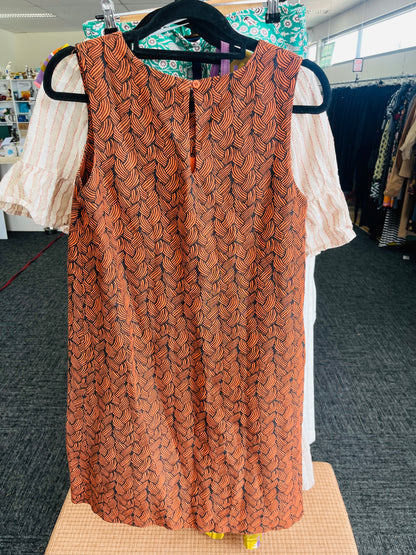 Patterned sleeveless top on a hanger