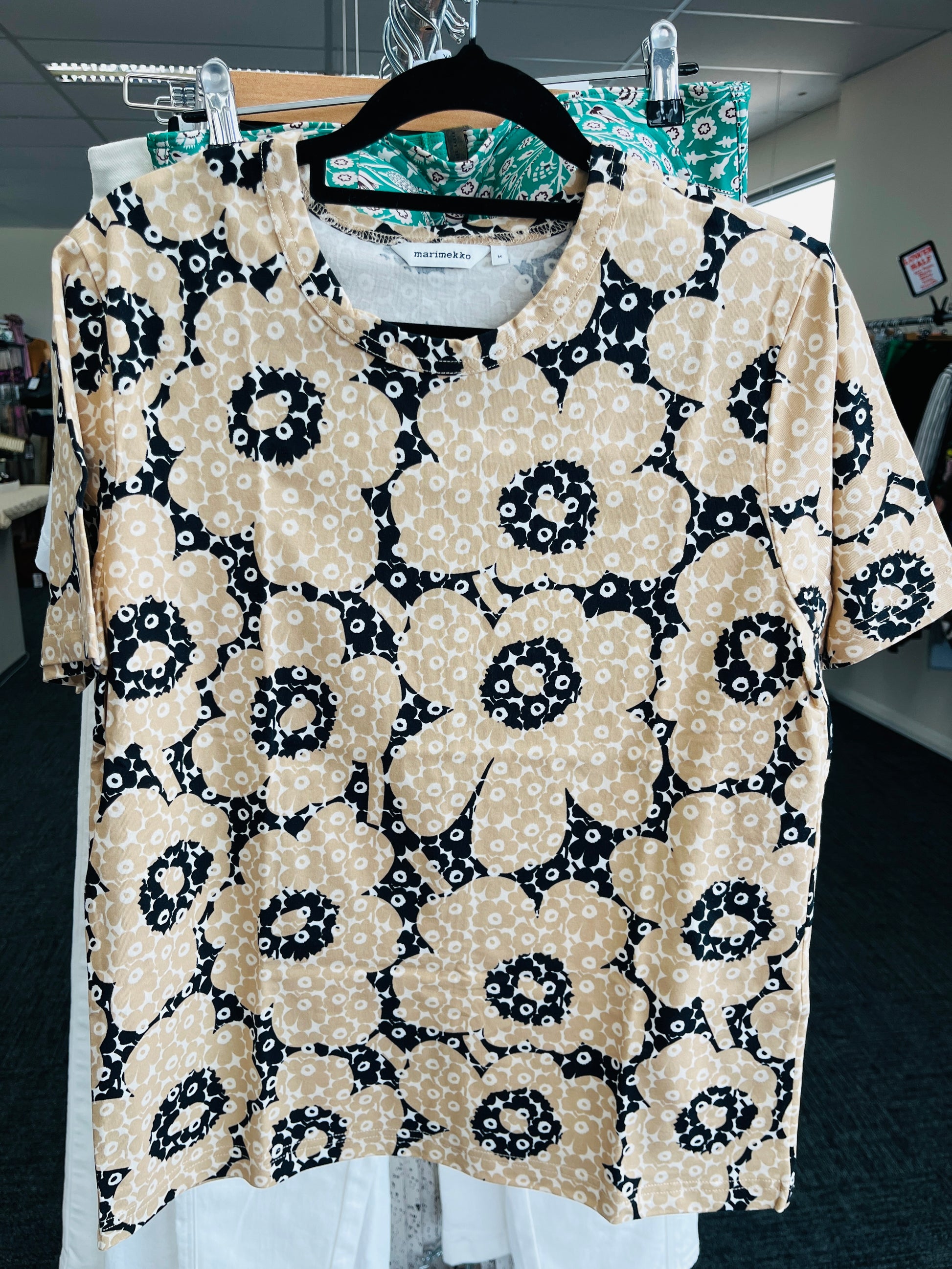 Floral patterned blouse on a hanger