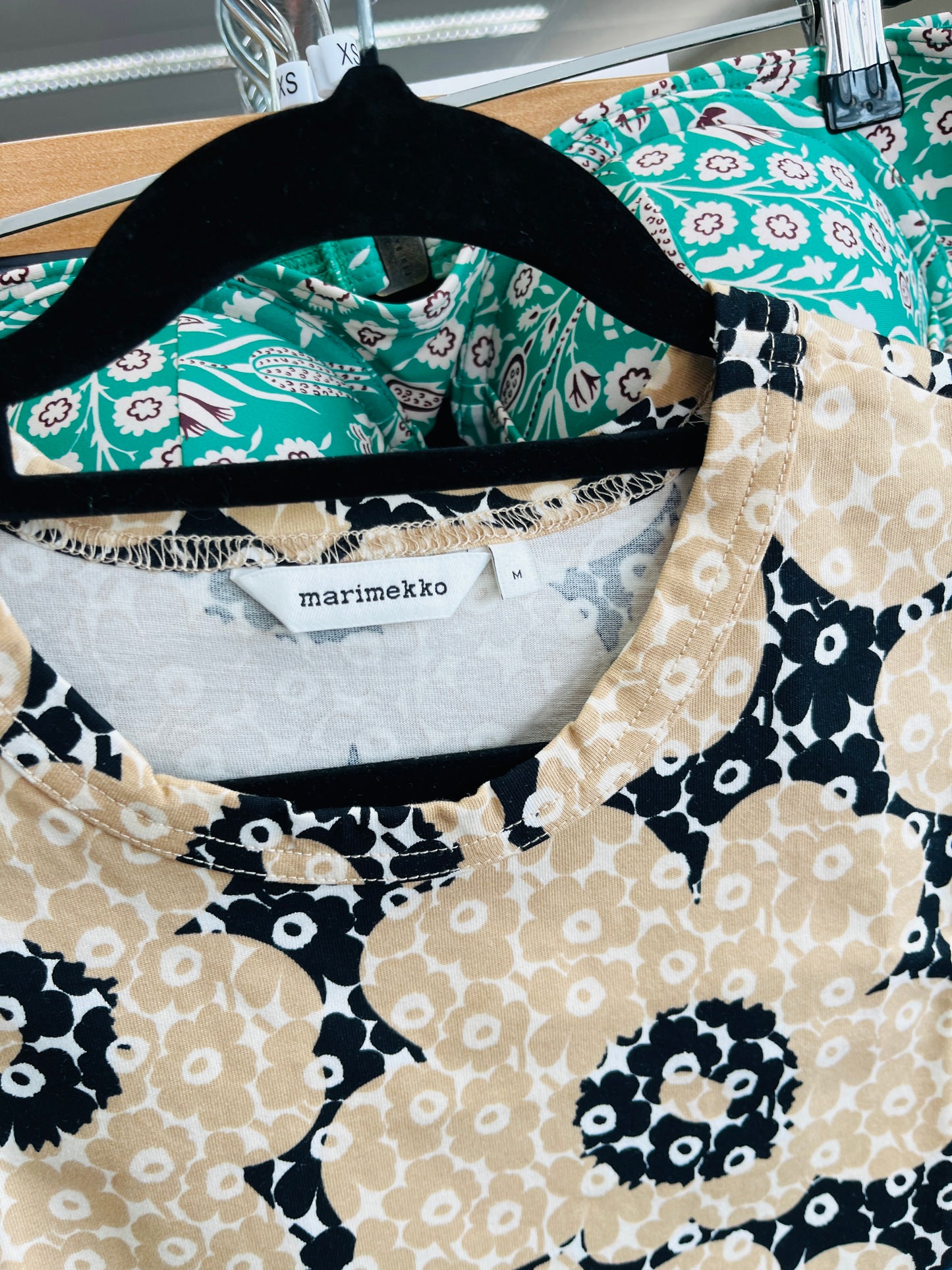 Patterned garment on a hanger with Marimekko label