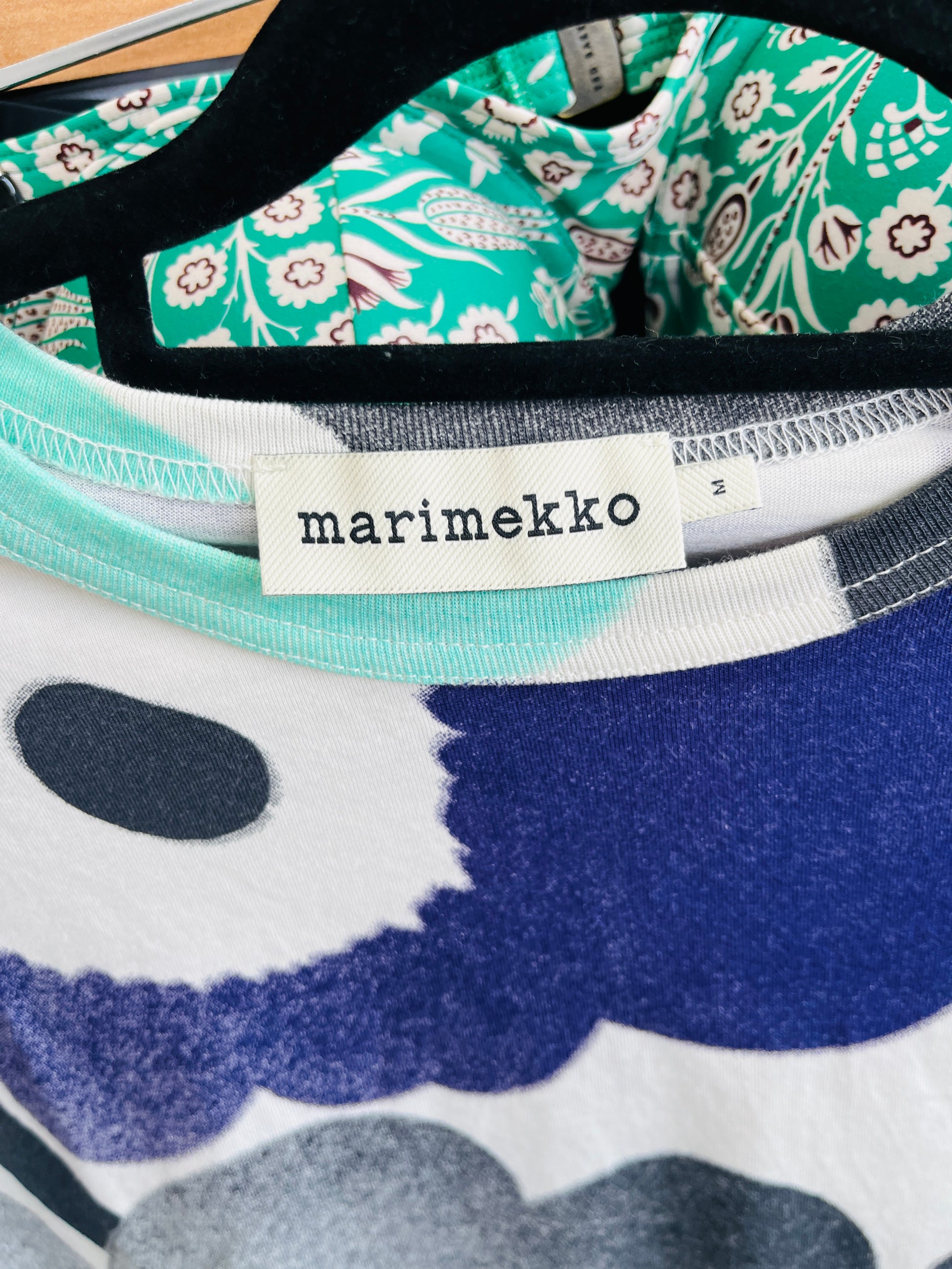 Close-up of a fabric with Marimekko label, featuring floral and abstract patterns.