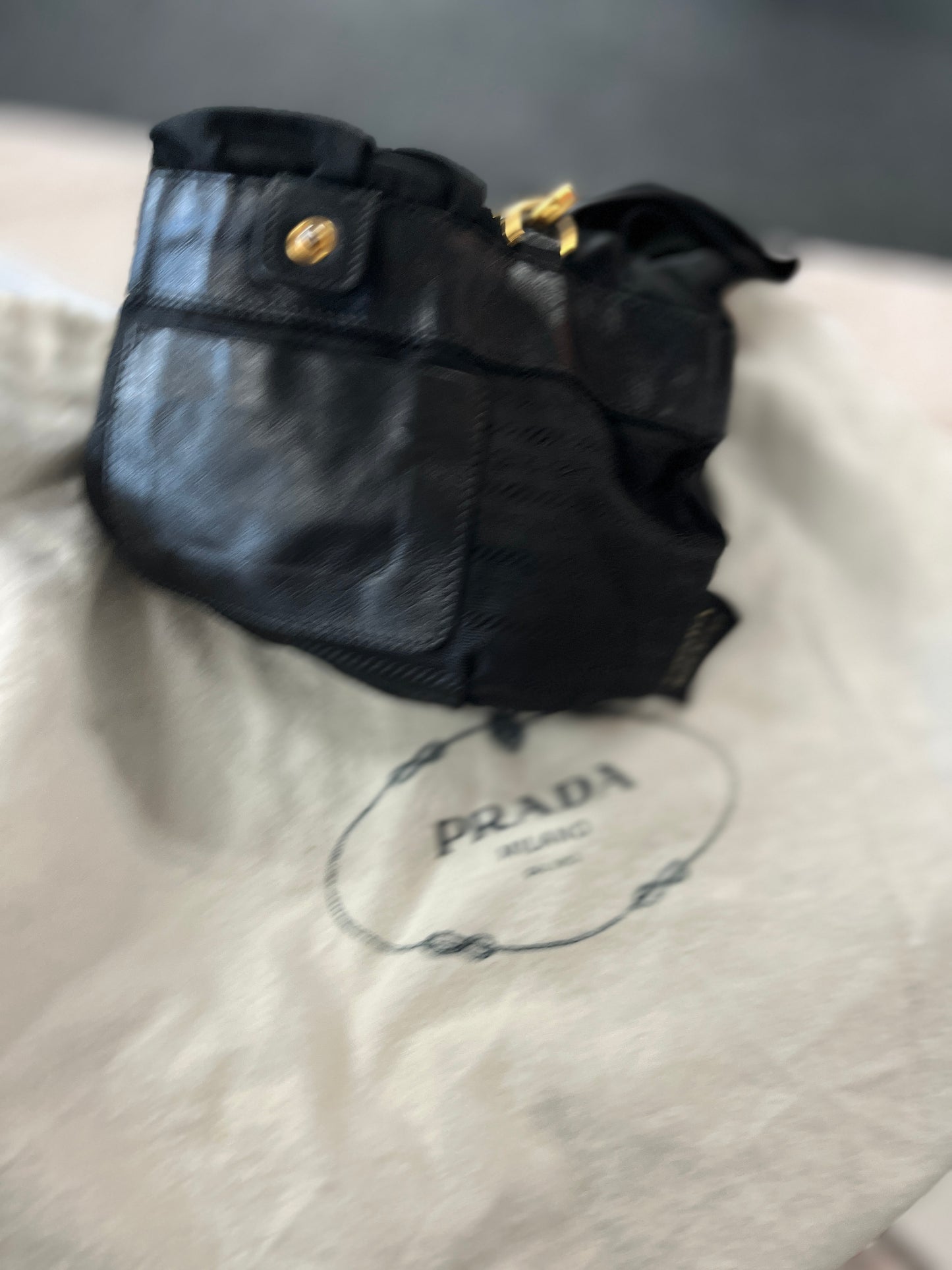 Black leather handbag with gold clasp