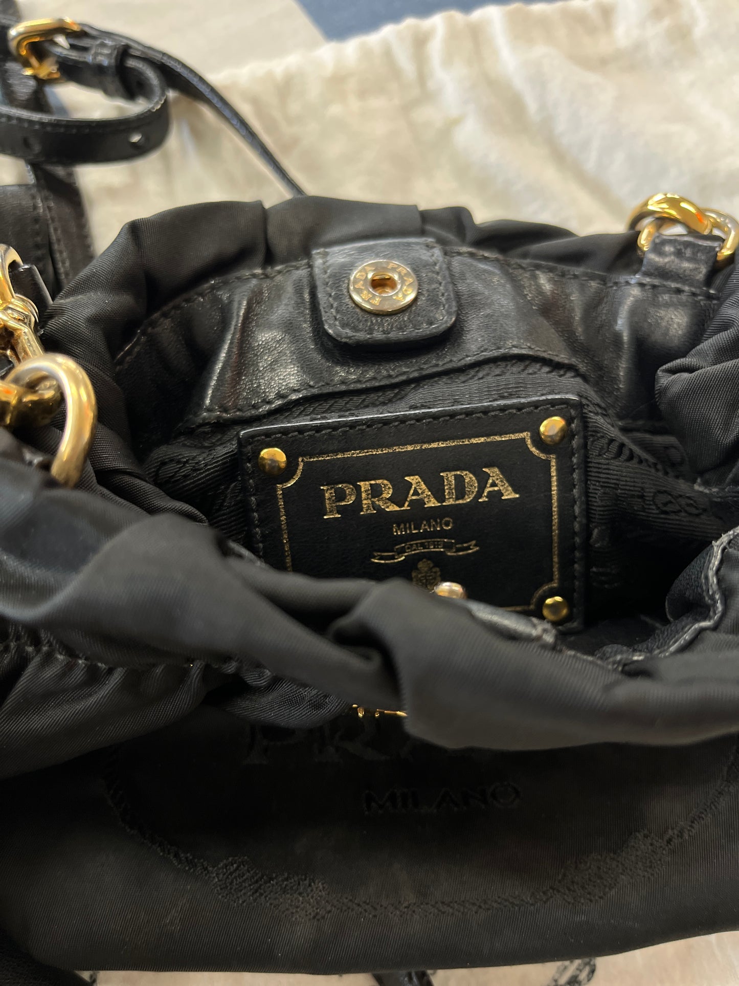 Close-up of a Prada handbag with gold hardware.