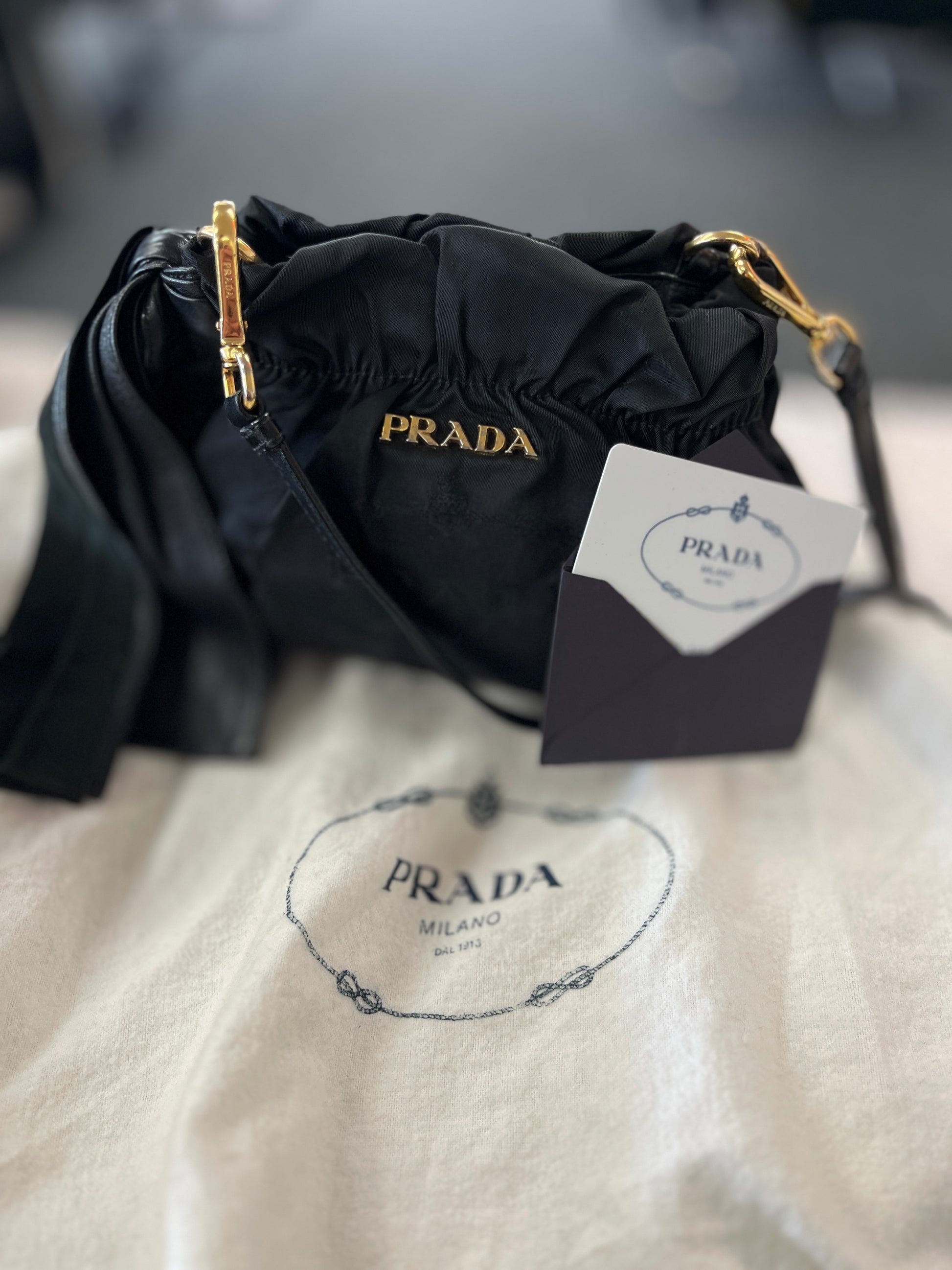 Black Prada handbag with gold accents